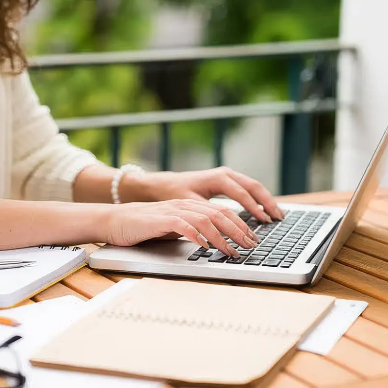 Side view of woman working on laptop, selective focus